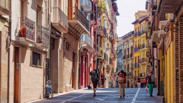 Pilgrims approach the city centre on Calle del Carmen in Pamploma